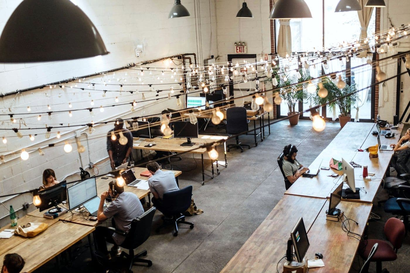 A long, bright workspace with teams at work.