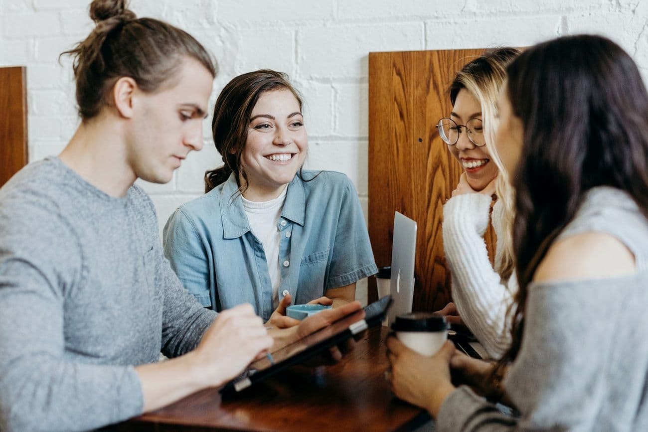 Colleagues working together at a table in a bright office.
